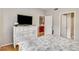Main bedroom with a dresser, hardwood floors, open bathroom, and neutral color palette at 2700 Pine Tree Ne Rd # 1117, Atlanta, GA 30324