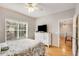 Main bedroom with hardwood floors, neutral color palette, and a view to the dining room at 2700 Pine Tree Ne Rd # 1117, Atlanta, GA 30324