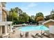 Community pool area with lounge chairs and umbrellas for relaxing by the water at 2700 Pine Tree Ne Rd # 1117, Atlanta, GA 30324