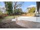 View of the home's backyard with a retaining wall and a metal fence along the top at 3388 Hyland Dr, Decatur, GA 30032