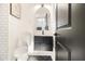 Stylish half bathroom with black vanity, herringbone floor, and arched mirror at 3388 Hyland Dr, Decatur, GA 30032