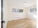 Bright bedroom with hardwood floors, neutral walls, and natural light from two windows at 3388 Hyland Dr, Decatur, GA 30032