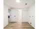 Bright laundry room with wood-look flooring and white walls at 3388 Hyland Dr, Decatur, GA 30032