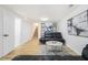 Finished basement living room with sleek black sofas and wood-look flooring at 3388 Hyland Dr, Decatur, GA 30032