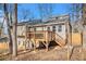 Rear exterior view showcasing the back deck, siding, and wooded lot at 6739 Valley Ct, Douglasville, GA 30135