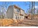 View of the backyard featuring a wooden fence, trees, and an elevated deck at 6739 Valley Ct, Douglasville, GA 30135