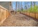Backyard with a wooden fence and tall trees at 6739 Valley Ct, Douglasville, GA 30135