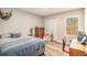 Cozy bedroom featuring a comfortable bed, wooden dresser, and a bright window view at 6739 Valley Ct, Douglasville, GA 30135