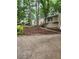 Inviting home featuring fresh mulch and a paved driveway amongst a scenic wooded landscape at 6739 Valley Ct, Douglasville, GA 30135