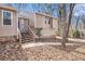 Home featuring siding, stone foundation, wooden steps, and a manicured lawn at 6739 Valley Ct, Douglasville, GA 30135