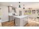 Open kitchen with island, stainless appliances, and adjacent dining area at 6739 Valley Ct, Douglasville, GA 30135