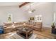 Bright living room featuring a sectional sofa, ceiling fan, skylights and wood floors at 6739 Valley Ct, Douglasville, GA 30135