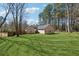A well-manicured backyard offering privacy, featuring a lush lawn and exterior view of the home at 140 Double D Rd, Temple, GA 30179