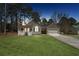 Charming single-story home featuring a covered porch, attached garage, and well-maintained lawn at 140 Double D Rd, Temple, GA 30179
