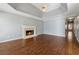 Spacious living room with fireplace, tray ceiling, and hardwood floors at 140 Double D Rd, Temple, GA 30179