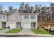 Charming townhome exterior with gray siding, single-car garage, and a well-manicured lawn at 4283 Notting Hill Dr # 66, Atlanta, GA 30331