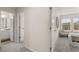 Hallway with carpet leading to the bathroom and bedroom with a chair at 58 Leggett Dr # 186, Villa Rica, GA 30180