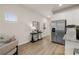 Open living space with white walls, wood floors, windows, and stainless steel refrigerator at 58 Leggett Dr # 186, Villa Rica, GA 30180