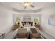 Bright bedroom with tray ceiling features two chairs, neutral decor and ample light at 58 Leggett Dr # 186, Villa Rica, GA 30180
