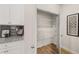 Open pantry with white wire shelving and wood floor is adjacent to kitchen countertop at 58 Leggett Dr # 186, Villa Rica, GA 30180