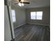 Cozy bedroom with new flooring, windows offering natural light, and a ceiling fan for added comfort at 123 Oldenburg Dr, Riverdale, GA 30274