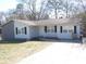 Charming single story home with a gray exterior, manicured lawn, and paved driveway, creating a welcoming curb appeal at 123 Oldenburg Dr, Riverdale, GA 30274