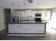 Newly renovated kitchen featuring stainless steel appliances, modern countertops, and ample cabinet space at 123 Oldenburg Dr, Riverdale, GA 30274