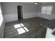 A spacious living room featuring new flooring, neutral wall color, and plenty of natural light at 123 Oldenburg Dr, Riverdale, GA 30274