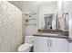 Bathroom featuring a toilet, sink, glass shelves and neutral tones creating a peaceful and tidy space at 215 Arizona Ne Ave # 1, Atlanta, GA 30307