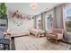 Bright bedroom with twin beds, decor, and a pink rocking armchair, complemented by natural light at 215 Arizona Ne Ave # 1, Atlanta, GA 30307