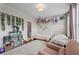 Bright bedroom with twin beds, decor, and a pink armchair, creating a cozy and inviting space at 215 Arizona Ne Ave # 1, Atlanta, GA 30307
