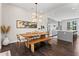 Open concept dining area with modern light fixture that is open to a kitchen at 215 Arizona Ne Ave # 1, Atlanta, GA 30307