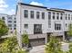 Charming three-story townhouse with painted white brick, a two car garage, and balcony at 215 Arizona Ne Ave # 1, Atlanta, GA 30307