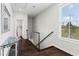 Well-lit upstairs hallway with hardwood floors and a modern railing system at 215 Arizona Ne Ave # 1, Atlanta, GA 30307
