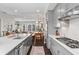 Bright, open concept kitchen with stainless steel appliances and quartz counters overlooks the dining area at 215 Arizona Ne Ave # 1, Atlanta, GA 30307