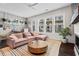Cozy living room with large windows, comfortable seating, and a fireplace at 215 Arizona Ne Ave # 1, Atlanta, GA 30307