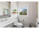 Stylish powder room with a pedestal sink, decorative mirror, and natural light at 215 Arizona Ne Ave # 1, Atlanta, GA 30307