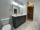 En-suite bathroom with double vanity, modern fixtures, a walk-in closet, and a tile floor at 229 Evergreen Trail Unit C, Cartersville, GA 30121