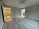 Spacious bedroom with carpet, a ceiling fan, and multiple doors leading to other rooms at 229 Evergreen Trail Unit C, Cartersville, GA 30121