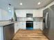 Bright kitchen with white cabinets, stainless steel appliances, granite countertops, and backsplash at 229 Evergreen Trail Unit C, Cartersville, GA 30121