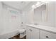 Updated bathroom with white fixtures and tiled shower over tub at 3435 Stallion Ct, Powder Springs, GA 30127