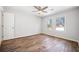 Bright bedroom features wood-look flooring, neutral walls, ceiling fan, and natural light at 3435 Stallion Ct, Powder Springs, GA 30127