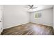 Bright bedroom features wood-look flooring, neutral walls, and a ceiling fan at 3435 Stallion Ct, Powder Springs, GA 30127