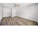 Bedroom with wood-look floors, neutral walls, ceiling fan, and a double-door closet at 3435 Stallion Ct, Powder Springs, GA 30127