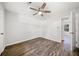 Neutral bedroom with wood-look floors, ceiling fan, and an adjacent room at 3435 Stallion Ct, Powder Springs, GA 30127