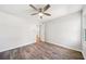 Neutral bedroom with a ceiling fan and wood-look flooring at 3435 Stallion Ct, Powder Springs, GA 30127
