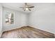 Comfortable bedroom with hardwood floors, ceiling fan, and natural light from a large window at 3435 Stallion Ct, Powder Springs, GA 30127