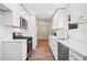 Bright modern kitchen features white cabinets, subway tile backsplash, stainless appliances and hardwood floors at 3435 Stallion Ct, Powder Springs, GA 30127