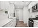 Modern kitchen with white cabinetry, subway tile backsplash, stainless steel appliances, and hardwood floors at 3435 Stallion Ct, Powder Springs, GA 30127