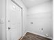 A bright laundry room that includes a storage shelf and connections for your washer and dryer at 3435 Stallion Ct, Powder Springs, GA 30127